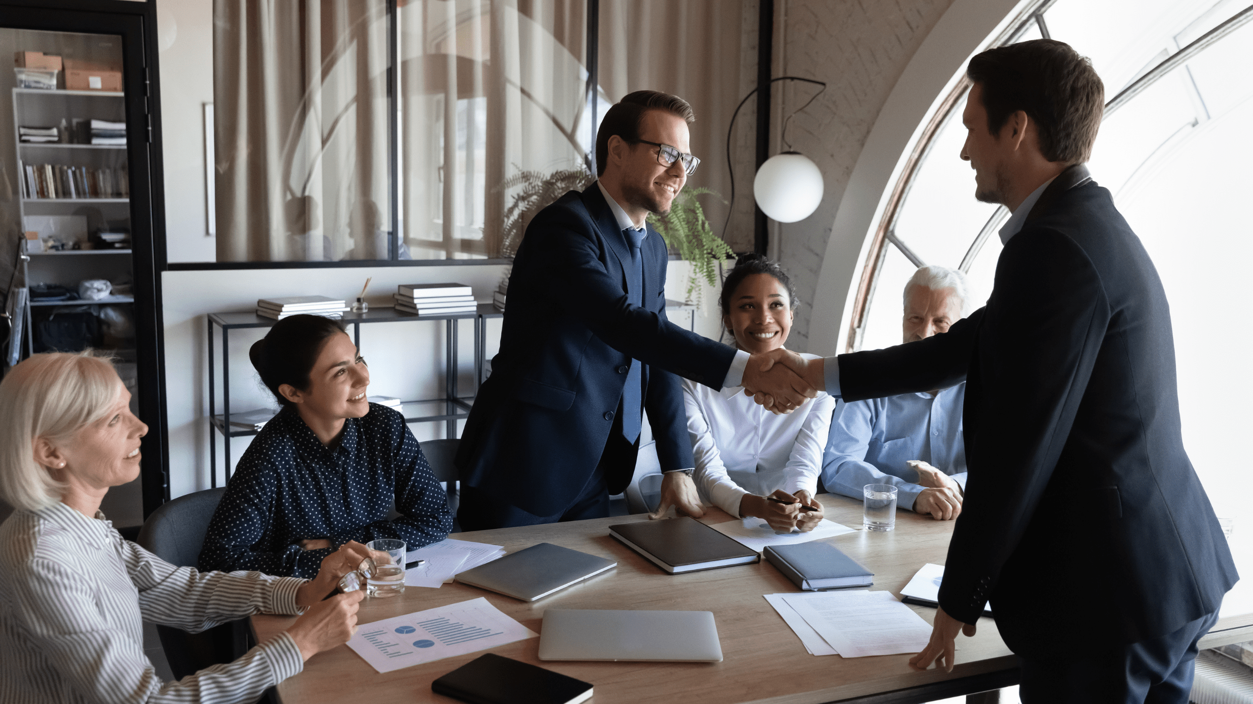 global HR managment strategy with two executives shaking hands